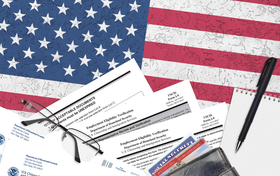 Form I-9 among other forms in front of an American flag