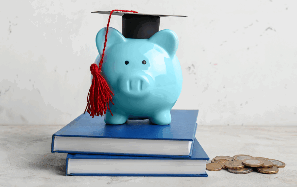 Blue piggy bank in a graduation cap on two books