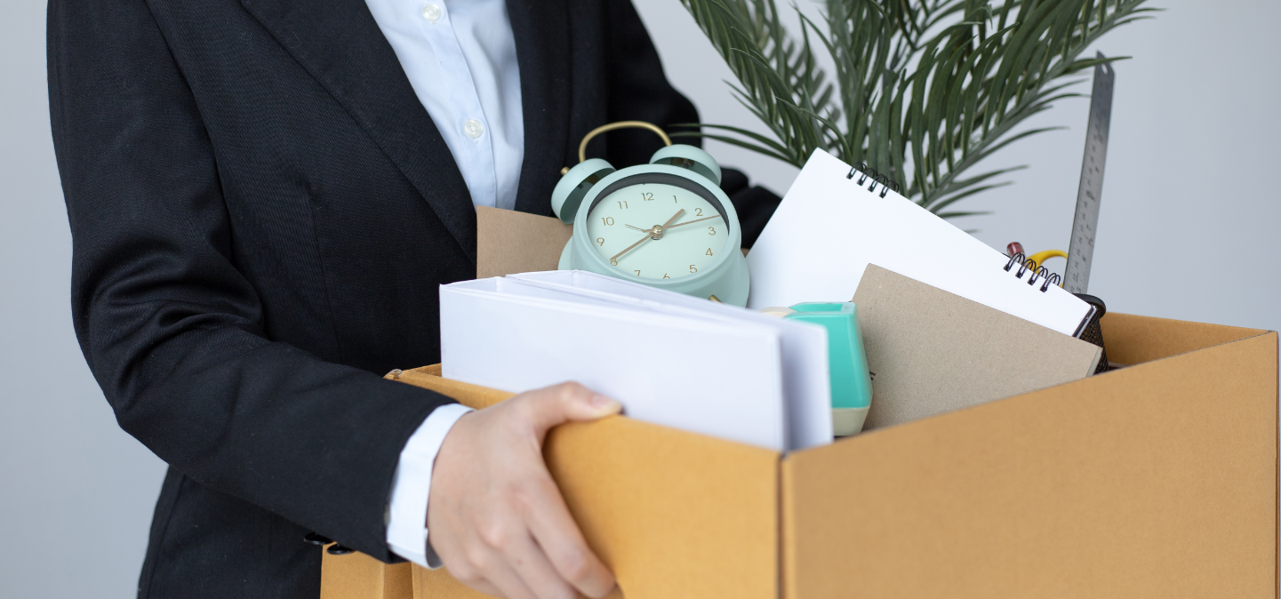 Employee holding box of office supplies