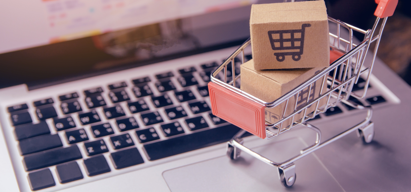 Mini shopping cart on a laptop keyboard