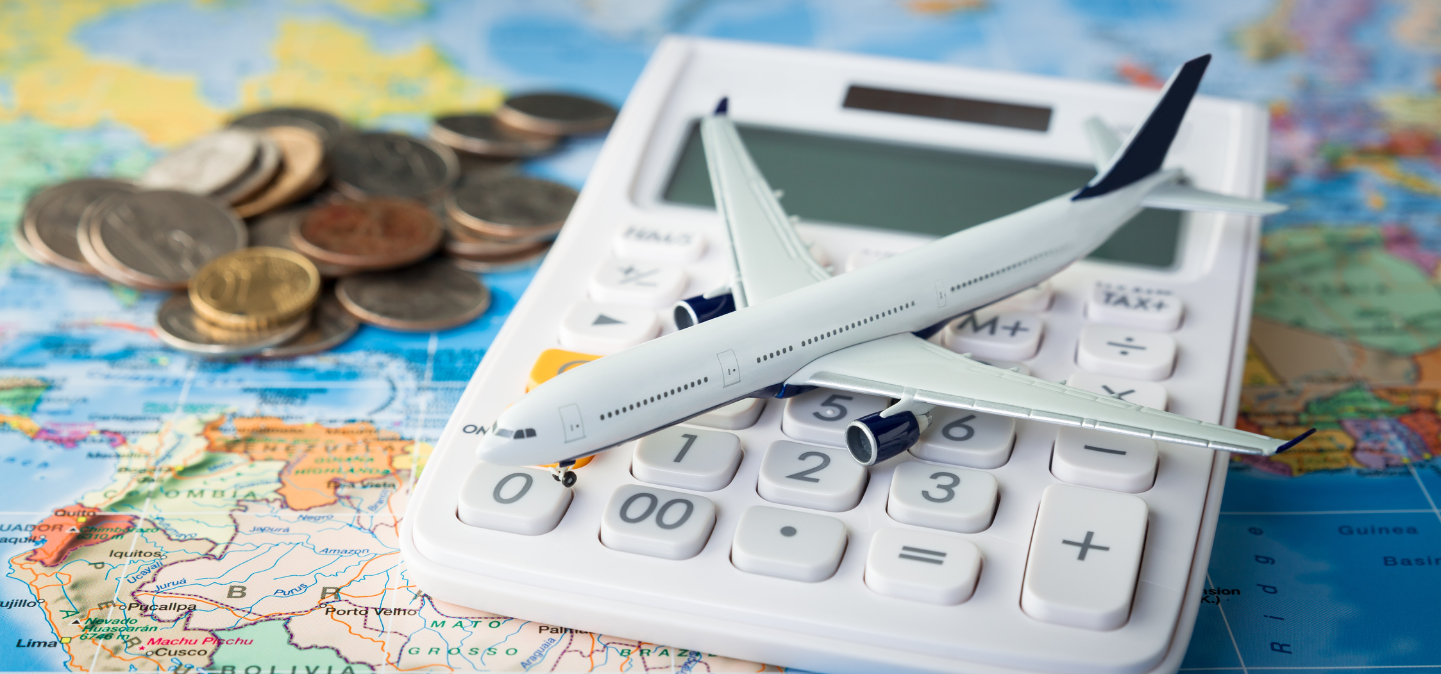 Toy plane on a calculator on a map; coins in background